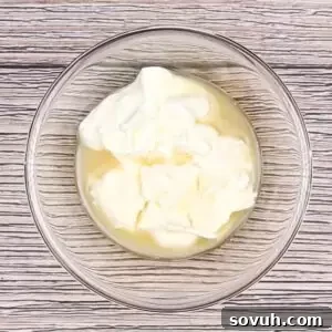 Velvety Spring Pea Salad 14 mixing the dressing for english pea salad in a glass bowl