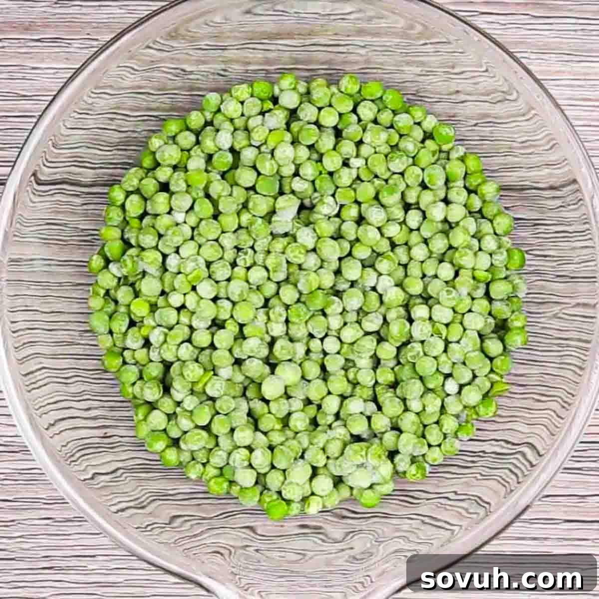 Velvety Spring Pea Salad 5 a glass bowl of frozen peas to make english pea salad