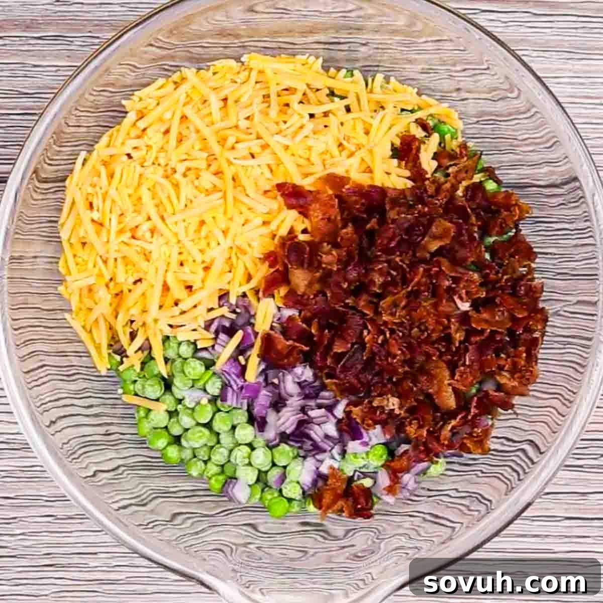 Velvety Spring Pea Salad 6 mixing ingredients in a glass bowl for english pea salad