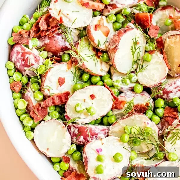 English Pea and Potato Salad is a light, fresh spring potato salad recipe with bright English peas, bacon, dill, and a creamy vinaigrette.