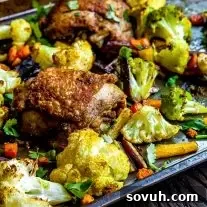 Close-up of chicken in Sheet Pan Chicken Curry and vegetables