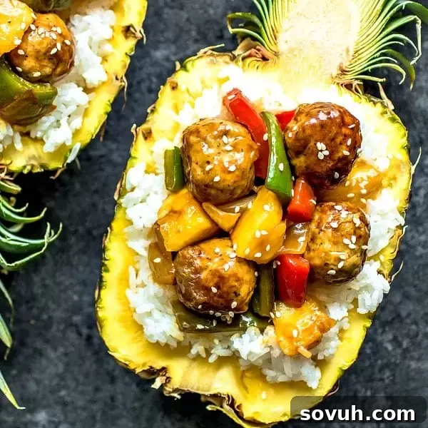 Pineapple Teriyaki Meatballs with rice in a pineapple bowl