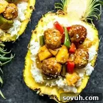 Pineapple Teriyaki Meatballs with rice in a pineapple bowl
