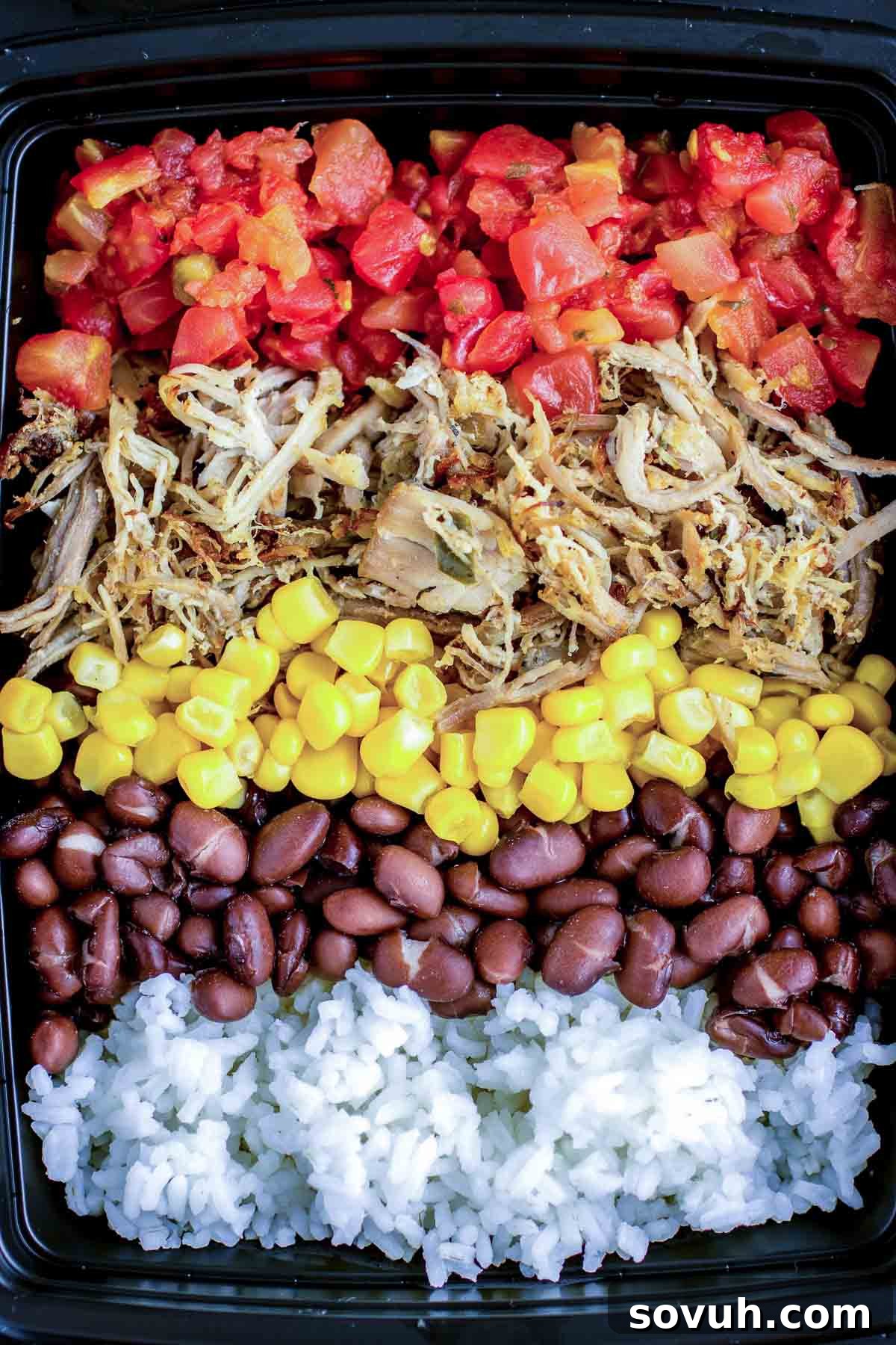 Slow Cooker Pulled Pork Carnitas packaged in meal prep containers with rice and beans