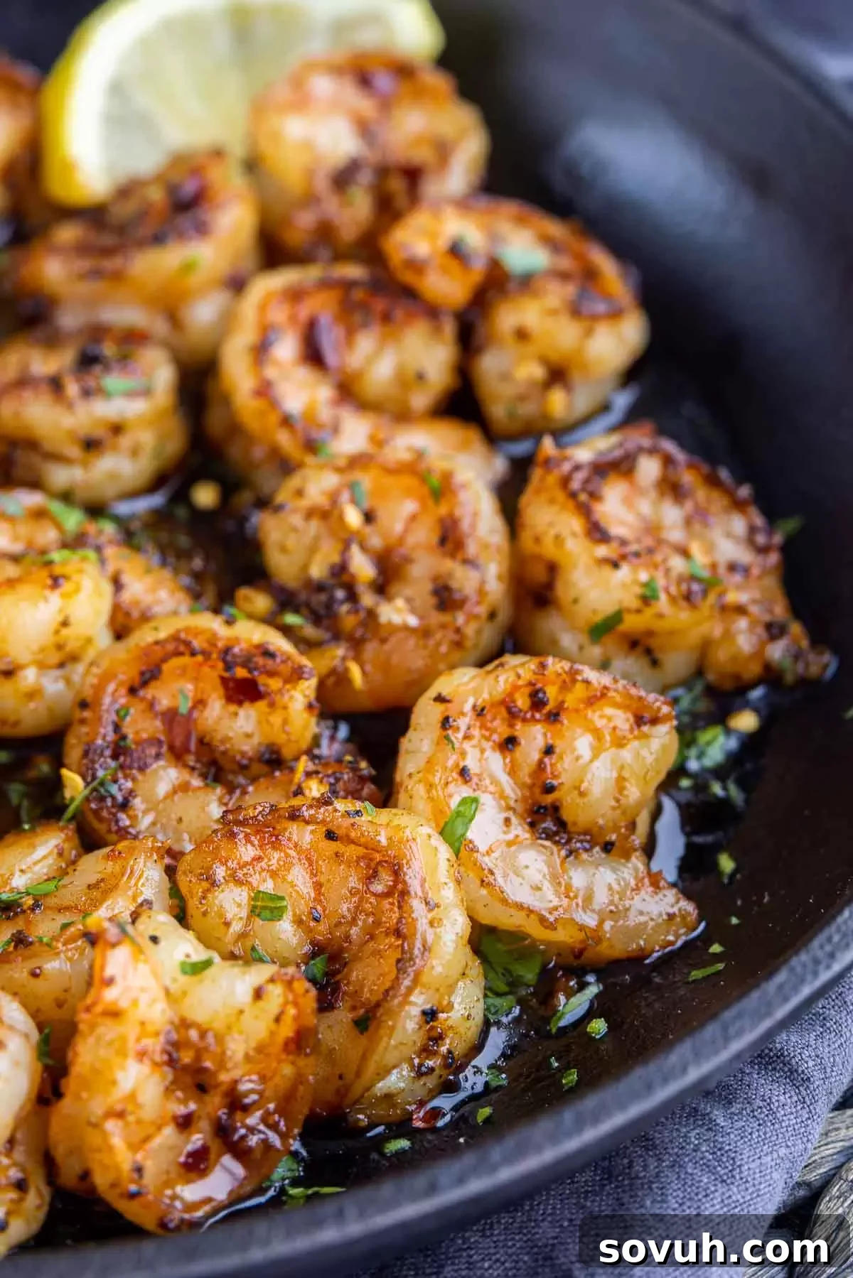 Sizzling Chili Garlic Shrimp 4 Sizzling Gambas Pil Pil in a skillet, showcasing the shrimp cooking in vibrant chili garlic oil.