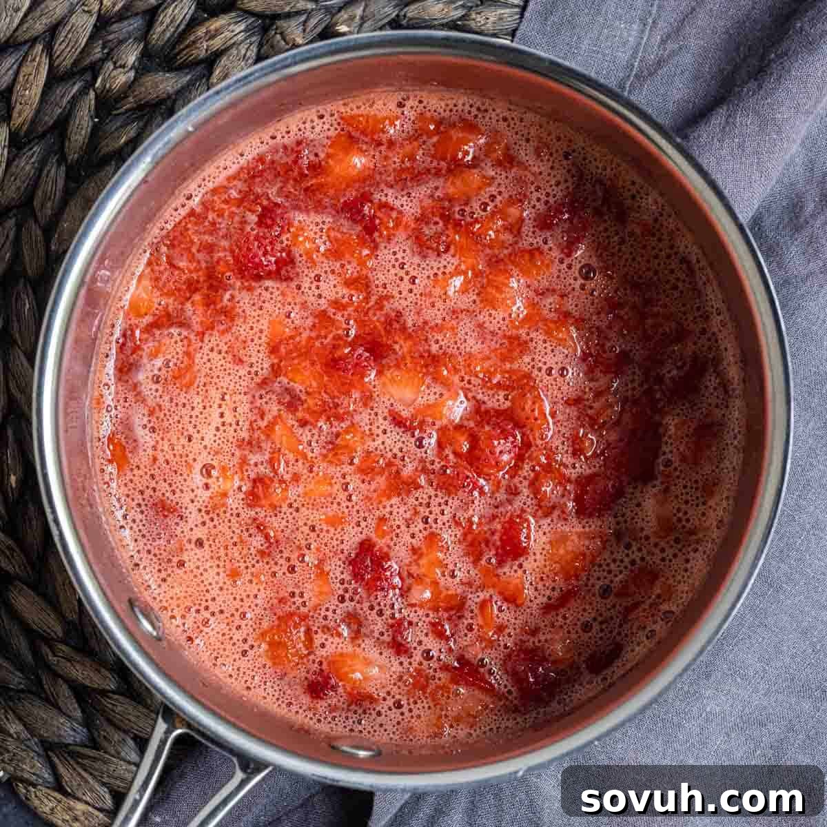 Saucepan with Strawberry Coulis boiling gently