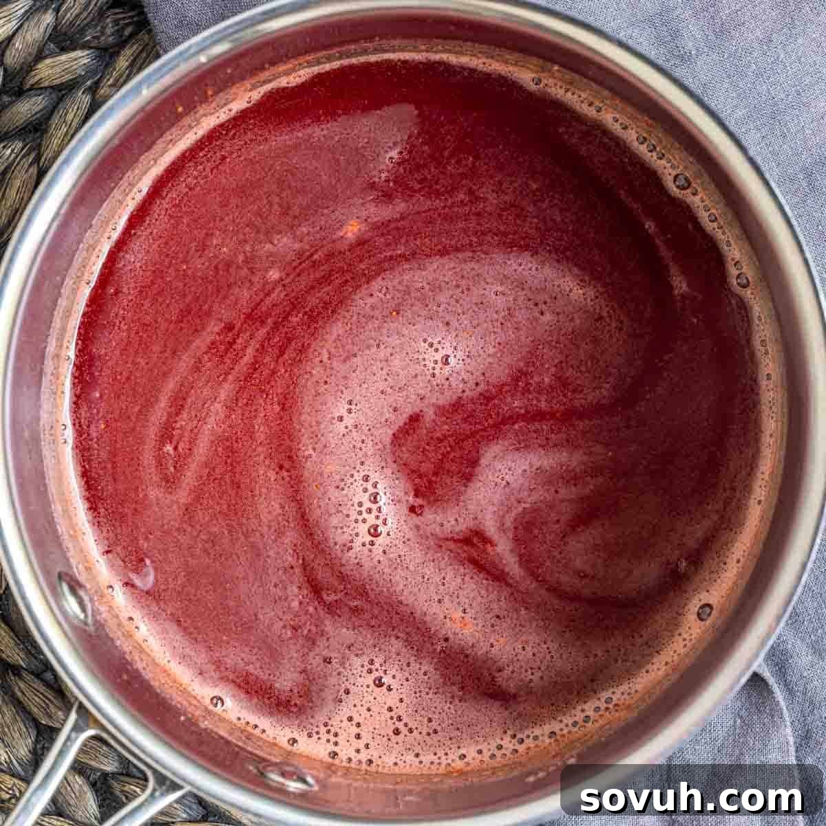 Strained Strawberry Coulis simmering in the saucepan