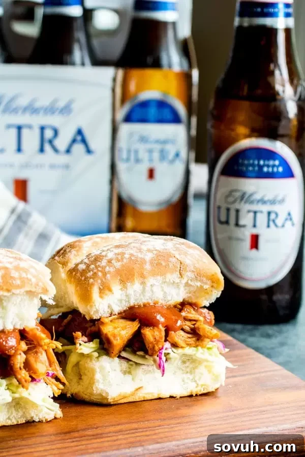Smoky Pulled Jackfruit Sliders 3 A vibrant platter of vegetarian BBQ Jackfruit Sliders alongside an ice-cold bottle of Michelob ULTRA beer, ready for a healthy and delicious celebration