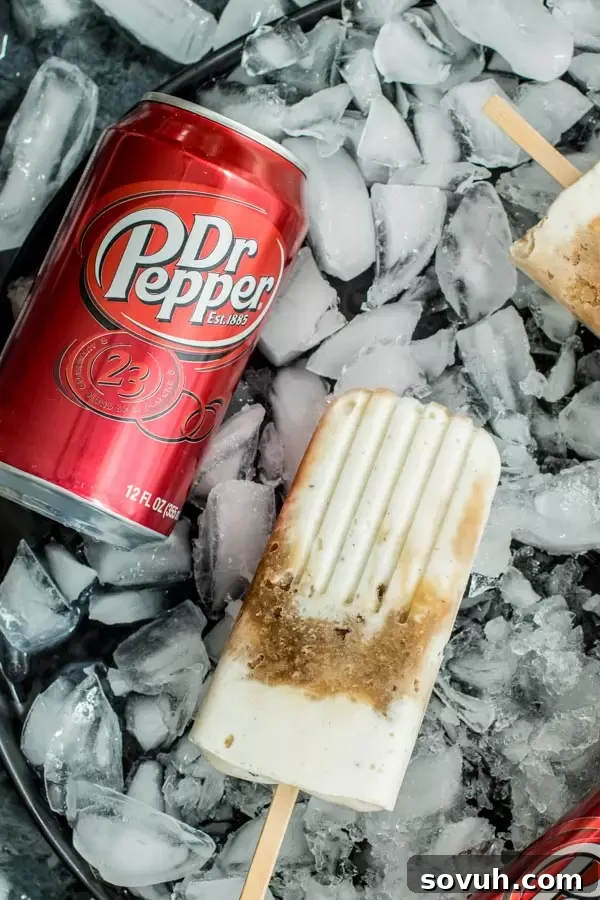 Dr. Pepper Popsicles chilling in a tray of ice, with a Dr. Pepper can in the background.