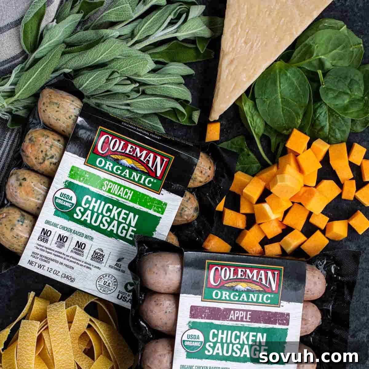 Ingredients for Creamy Butternut Squash and Sausage Pasta Packages of Coleman Organic chicken sausage with spinach and apple varieties are surrounded by fresh sage, spinach, cheese, butternut squash, and uncooked pasta.