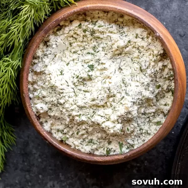 Homemade Ranch Seasoning Mix in a jar with fresh herbs