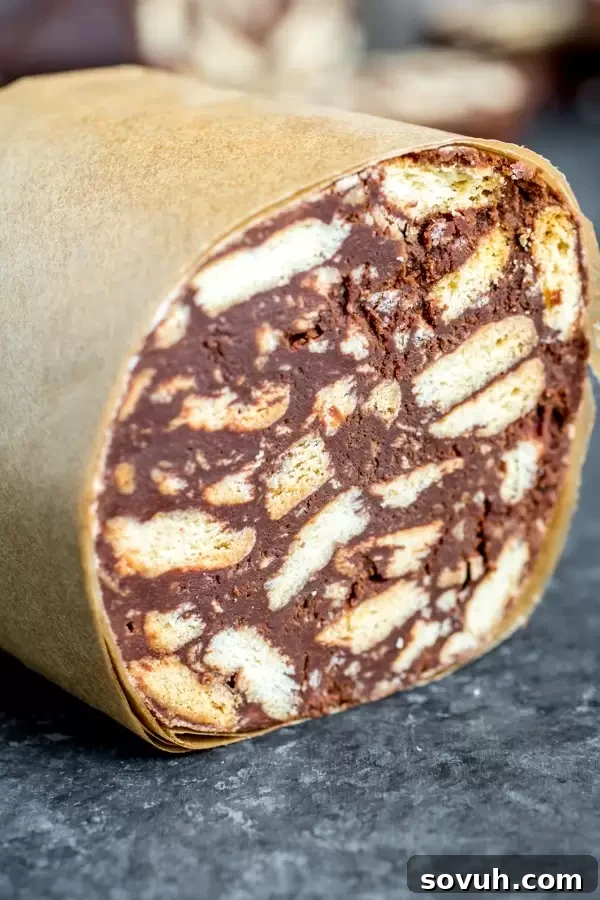 Half-unwrapped Chocolate Salami log, showing the dark chocolate and biscuit texture inside.