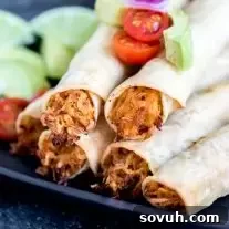 Chicken Taquitos stacked on plate