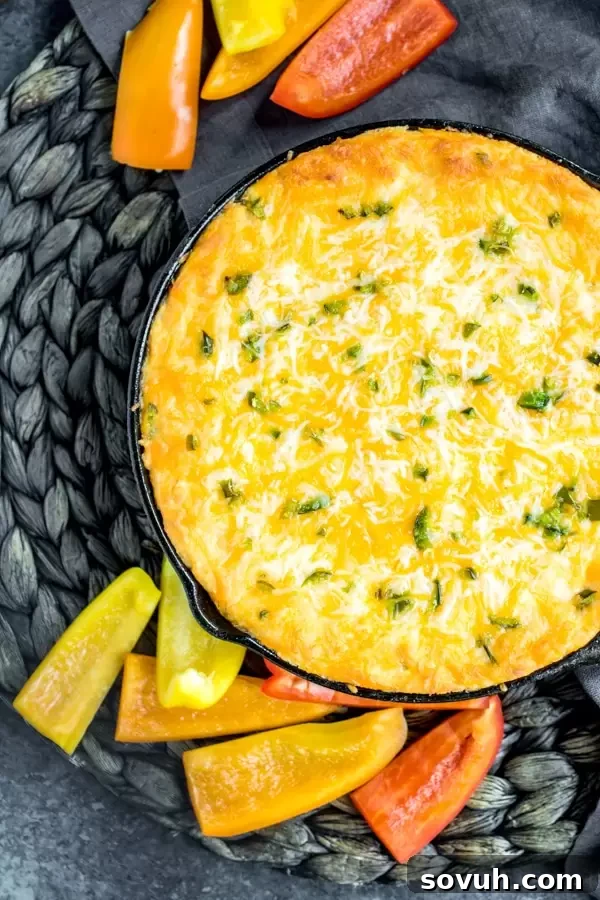 skillet of bubbling, hot Buffalo Chicken Jalapeno Popper Dip with melted cheese