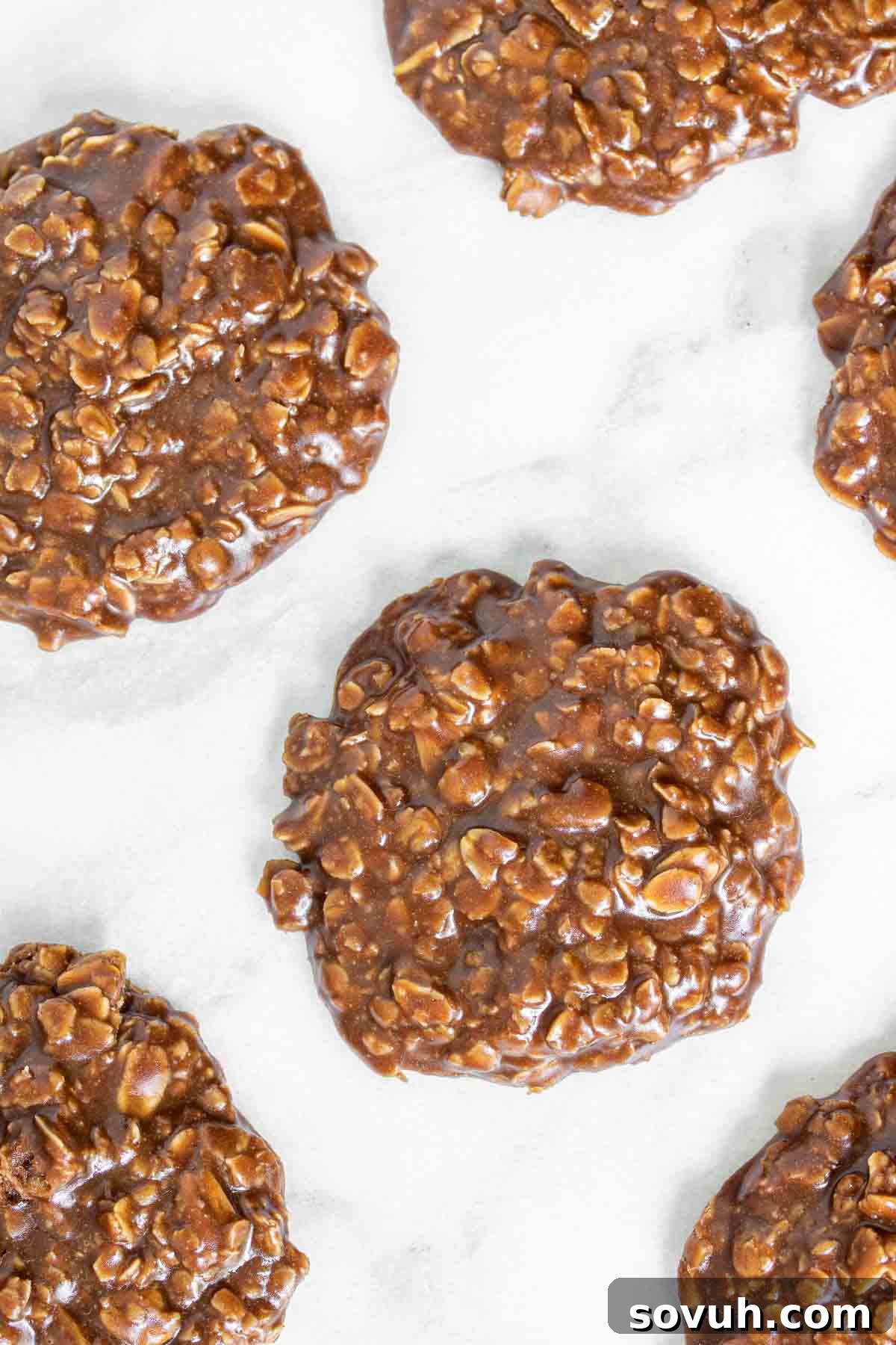 Freshly made No Bake Chocolate Oatmeal Cookies cooling on a marble surface