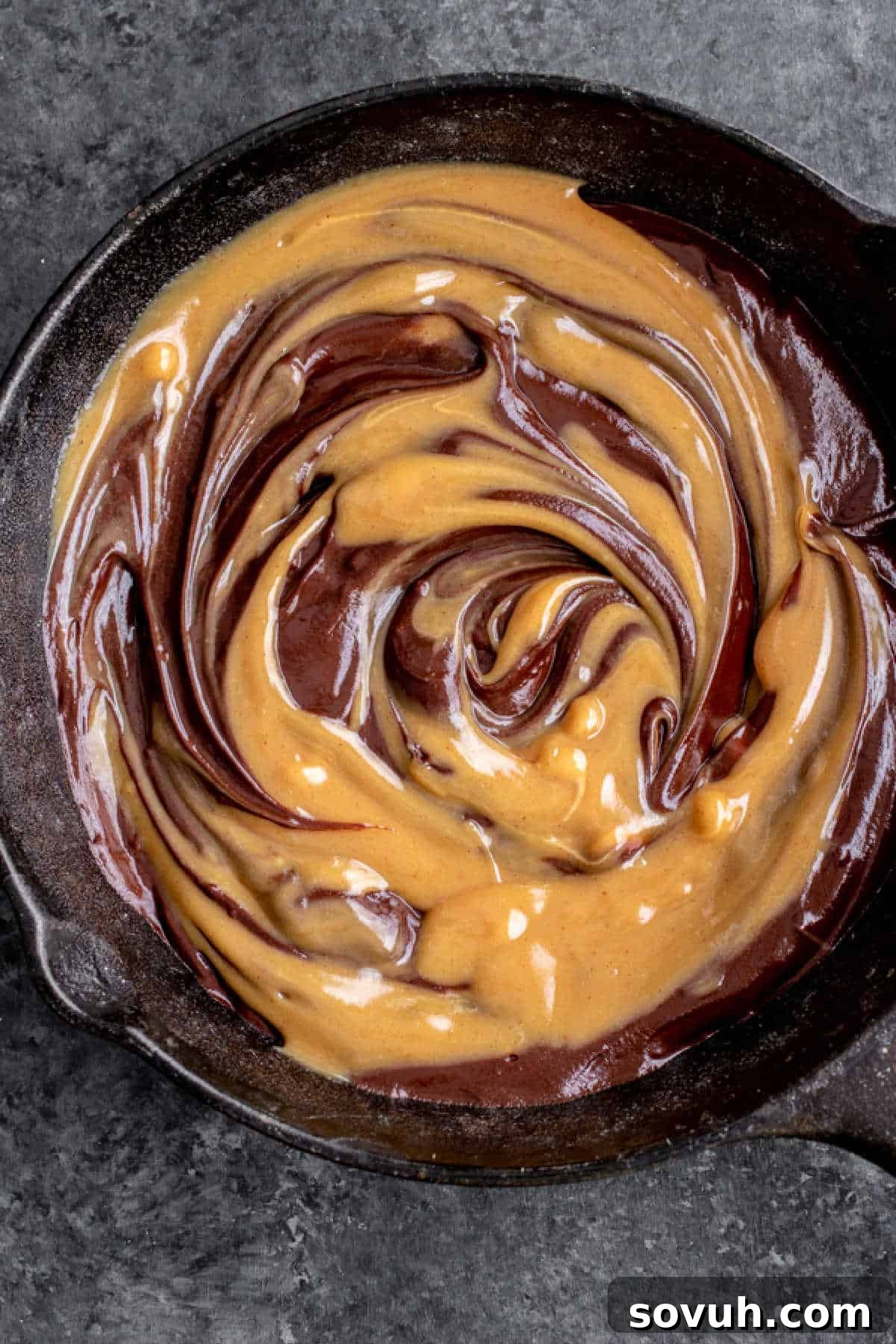 Close-up of Halloween S'mores Dip, showcasing the rich swirl of chocolate and peanut butter ganache before adding marshmallows.