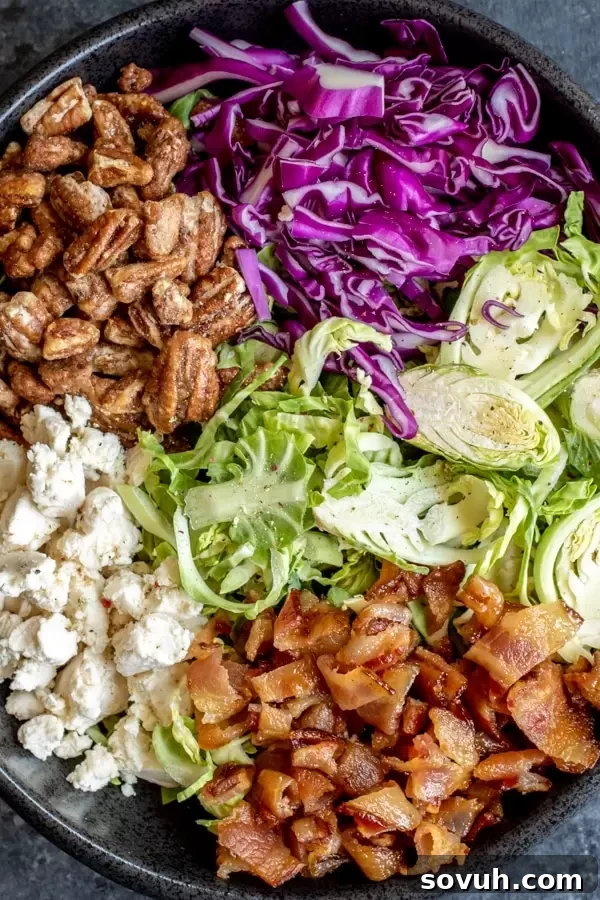 Ingredients in Brussels Sprout Salad bacon, goat cheese, candied pecans, brussels sprouts, red cabbage