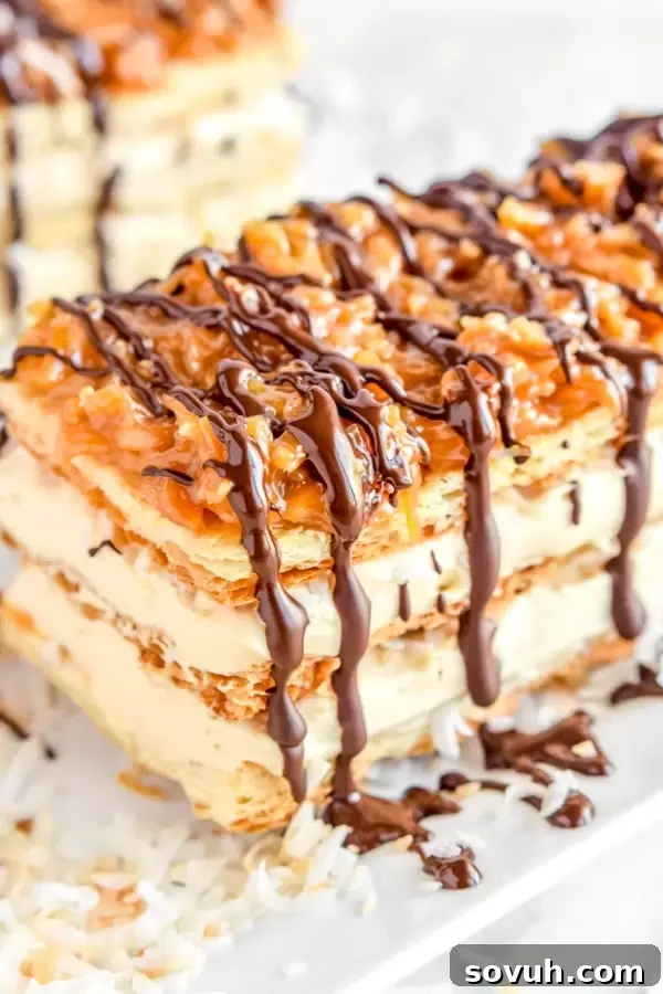 Close-up of chocolate and caramel Samoa Napoleons, showing the layers of pastry and cream with coconut topping.