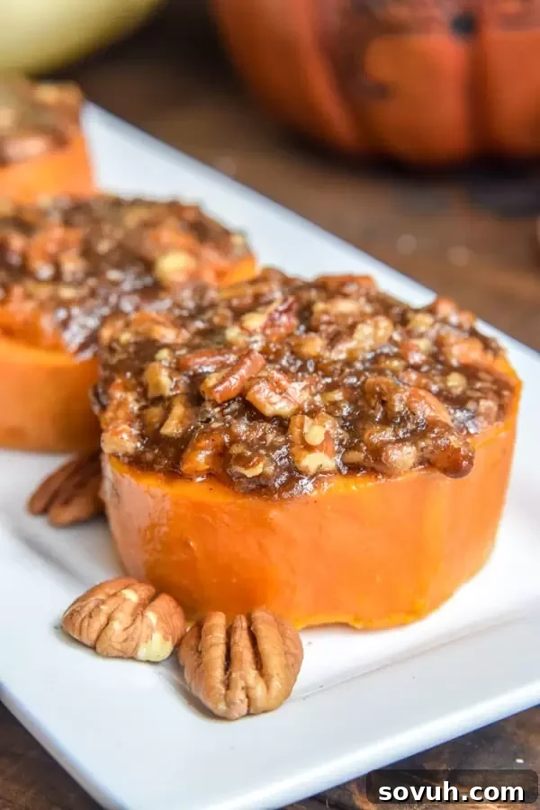 Three golden Mini Sweet Potato Casseroles with a rich brown sugar pecan topping, showcased on a wooden board