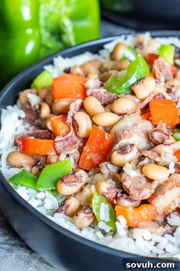 Instant Pot Hoppin' John elegantly served in a bowl, placed over a bed of fluffy white rice.