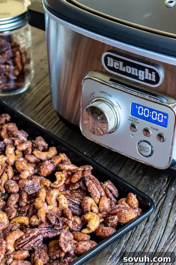 A close-up view of Slow Cooker Spiced Nuts cooling on a baking sheet after being removed from the De'Longhi Livenza Slow Cooker.