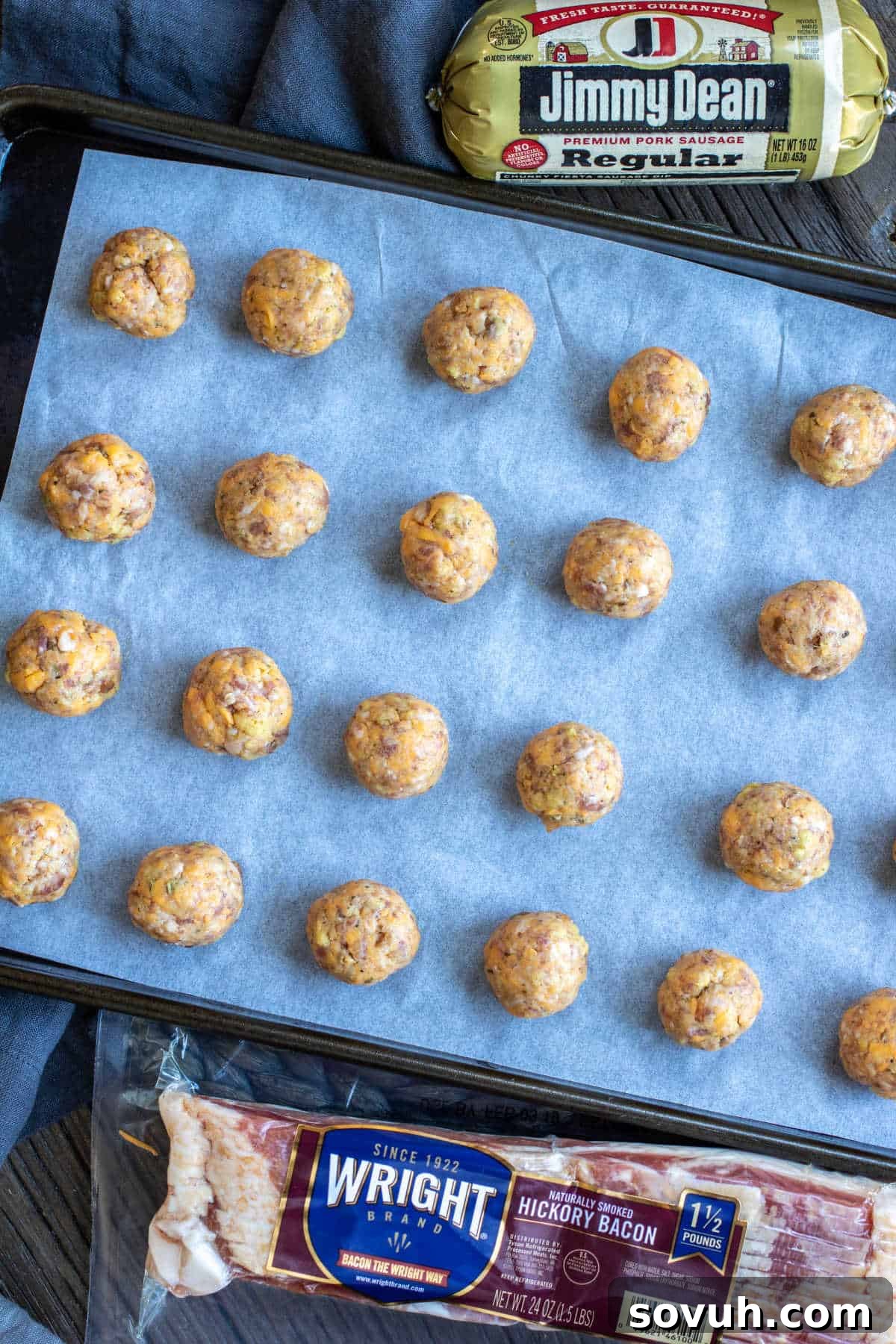 A close-up of hands expertly rolling the stuffing ball mixture into uniform, bite-sized spheres before baking.