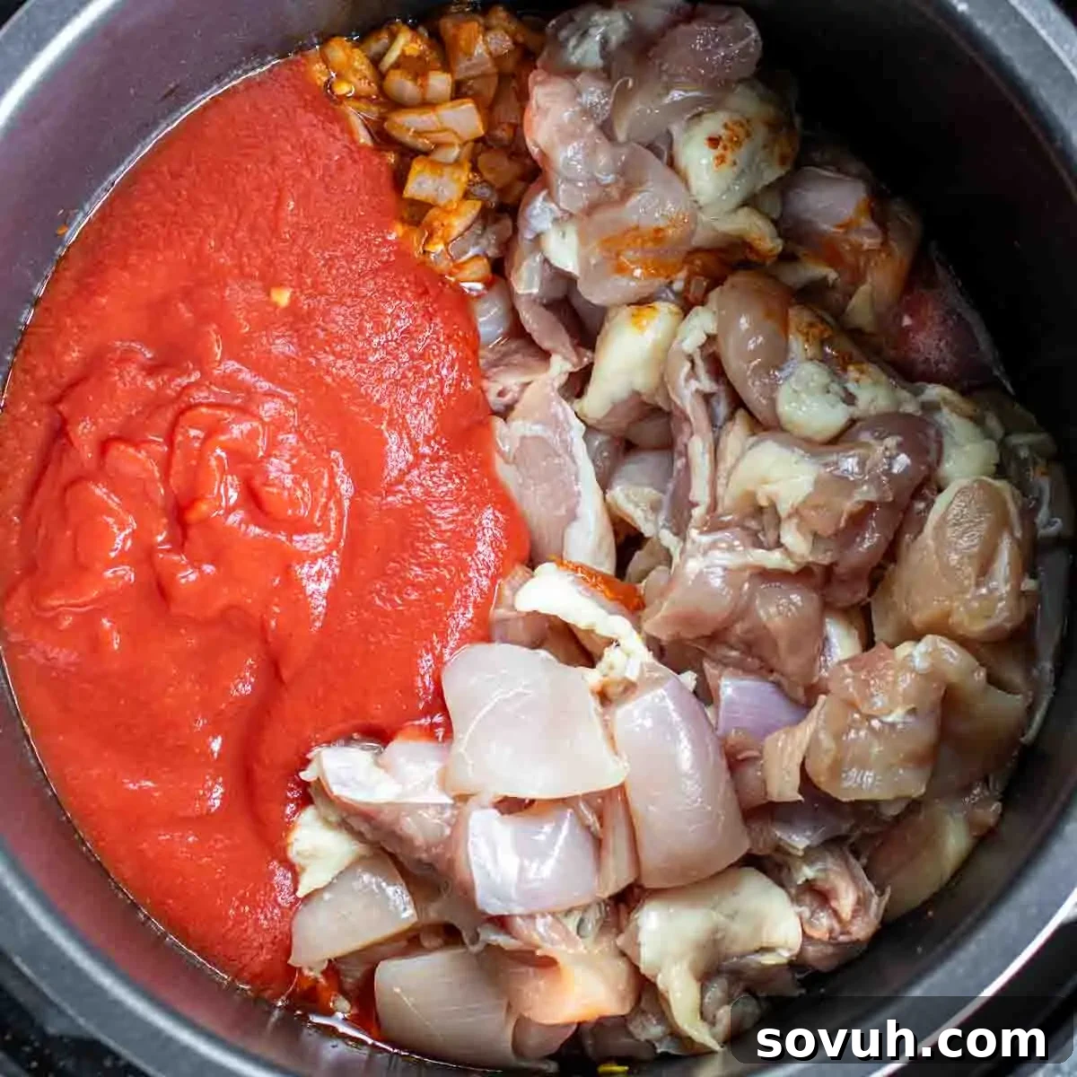 A vibrant bowl of Instant Pot Keto Butter Chicken, featuring succulent chicken in a rich, red, creamy sauce.