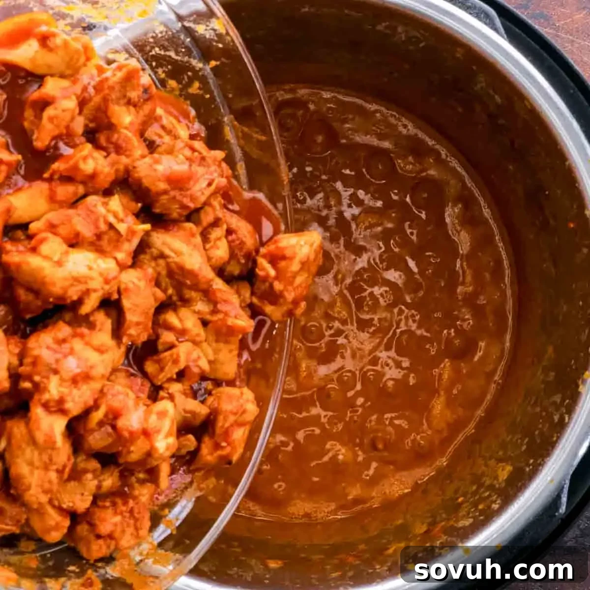 A serving of finished Instant Pot Keto Butter Chicken in a bowl, garnished with fresh cilantro.