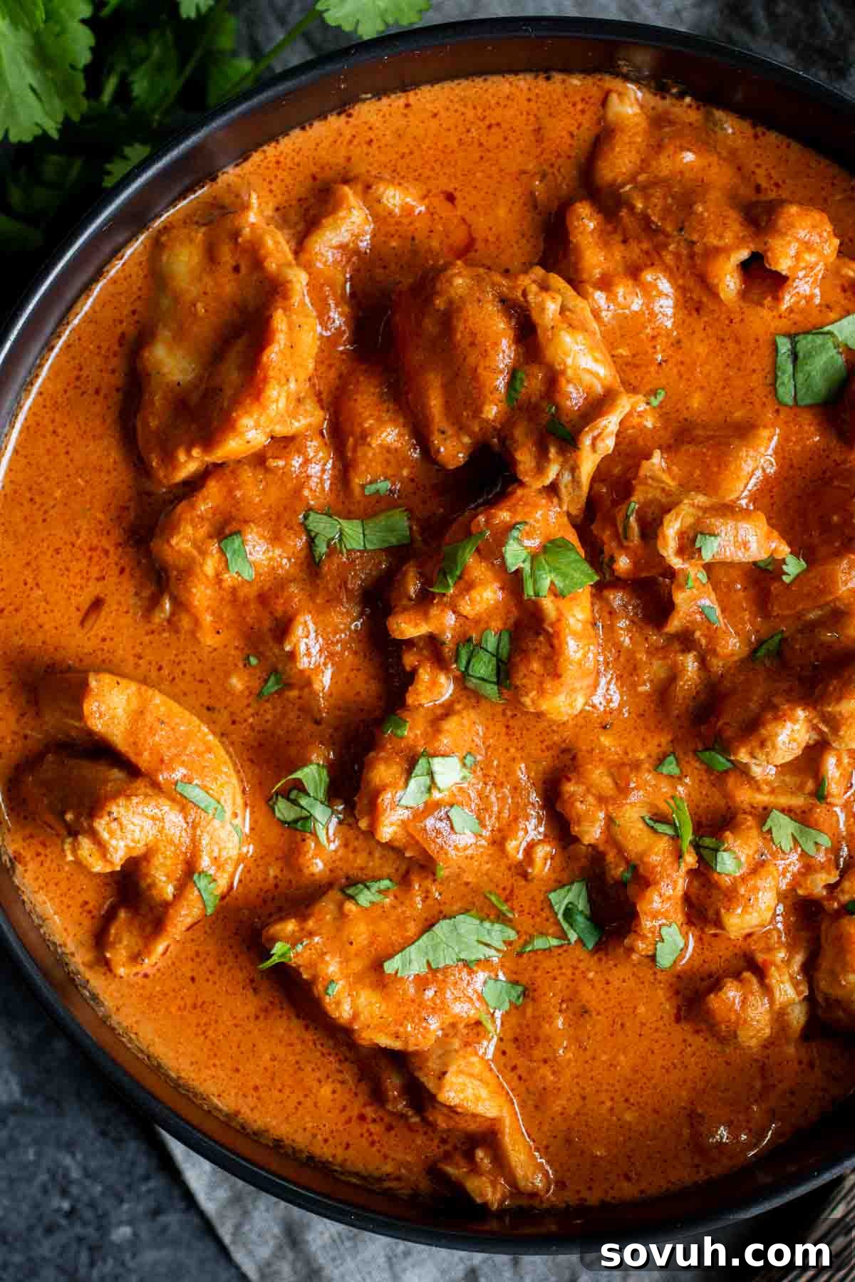 A black bowl filled with rich Instant Pot Keto Butter Chicken, ready to be enjoyed.