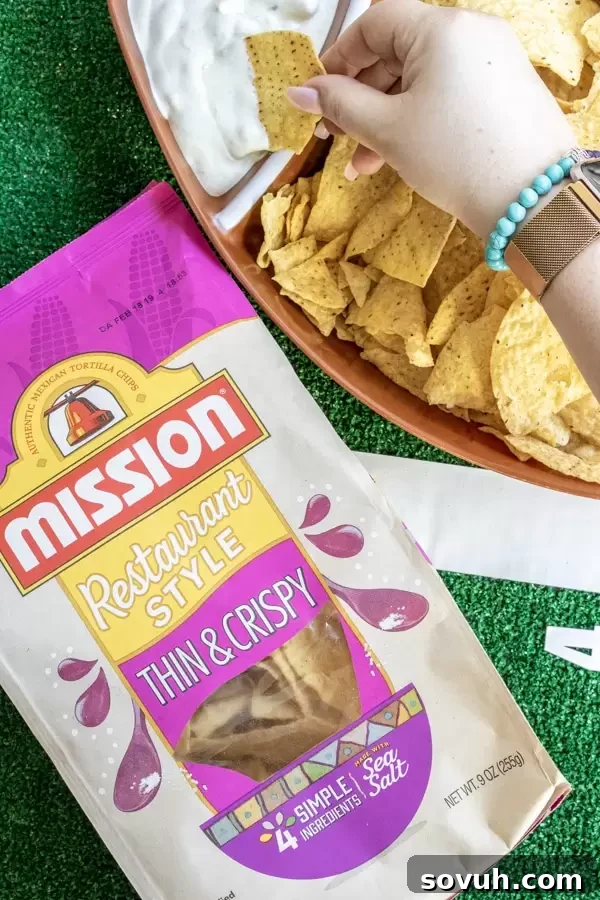 Mission tortilla chips and Instant Pot Pork Belly Tacos on a platter, ready for a party.