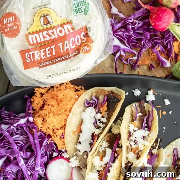 Mini Pork Belly Tacos, perfectly sized for snacking, arranged on a serving board.