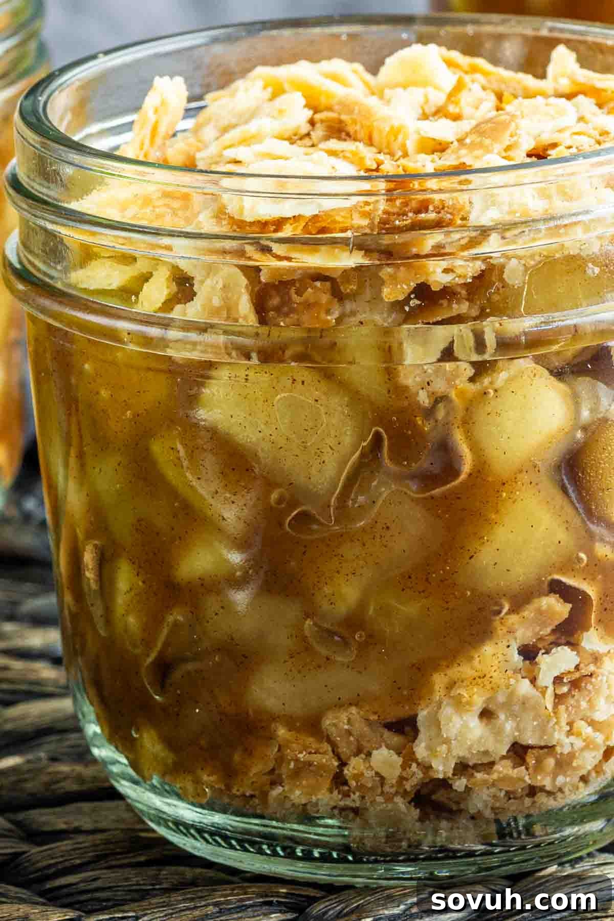 apple pie in a jar on a table.