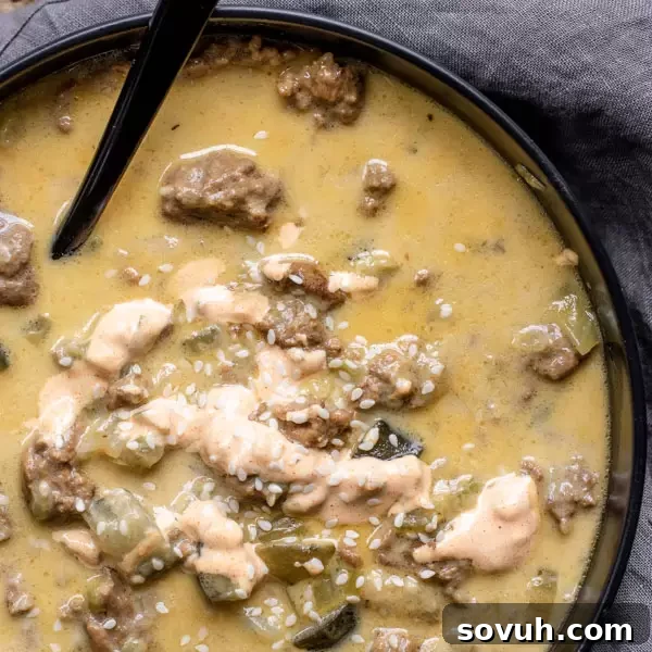 A big bowl of Instant Pot Big Mac Soup with a drizzle of special sauce, ready to be enjoyed.