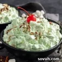 Watergate Salad in a bowl with a cherry on top