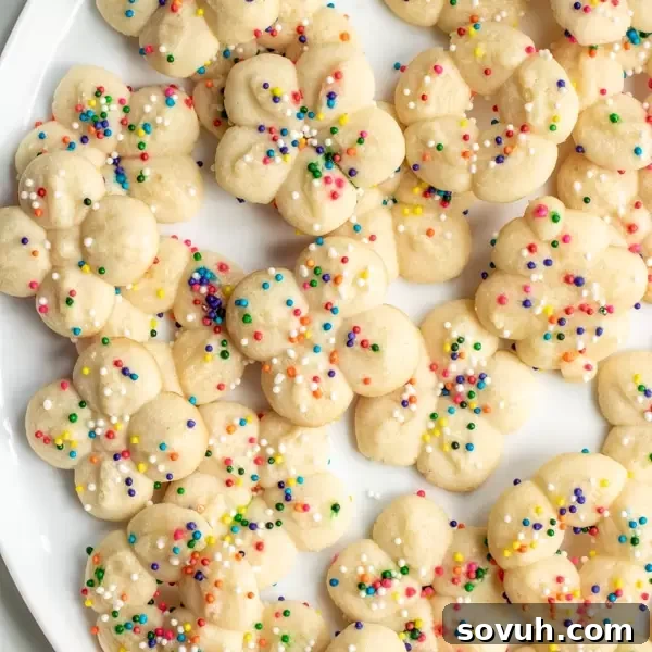 Platter of Cream Cheese Spritz Cookies, garnished with colorful sprinkles.