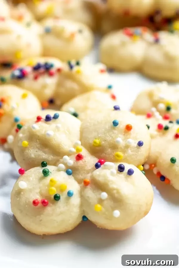 Easy make-ahead Cream Cheese Spritz Cookies cooling on a wire rack.