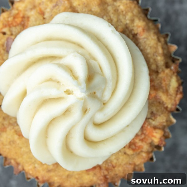 Delicious Keto Cream Cheese Frosting on a low carb carrot cake cupcake