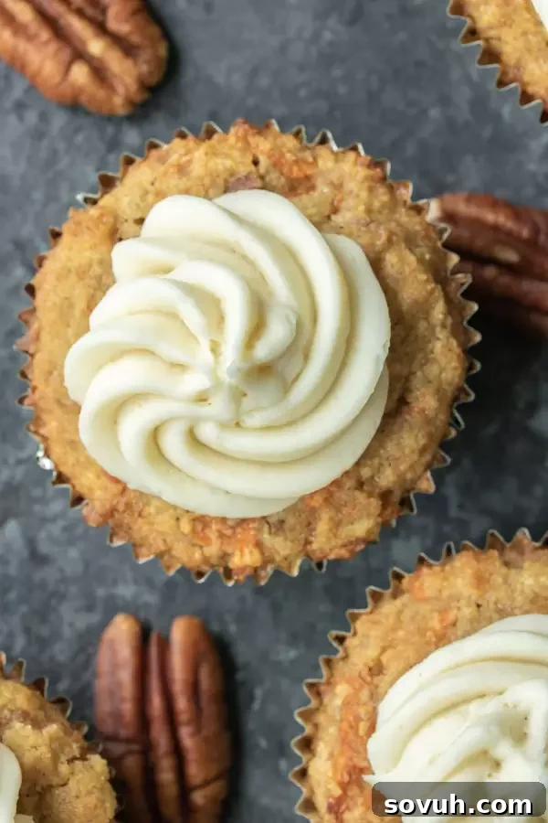 Low carb carrot cake cupcake topped with generous Keto Cream Cheese Frosting