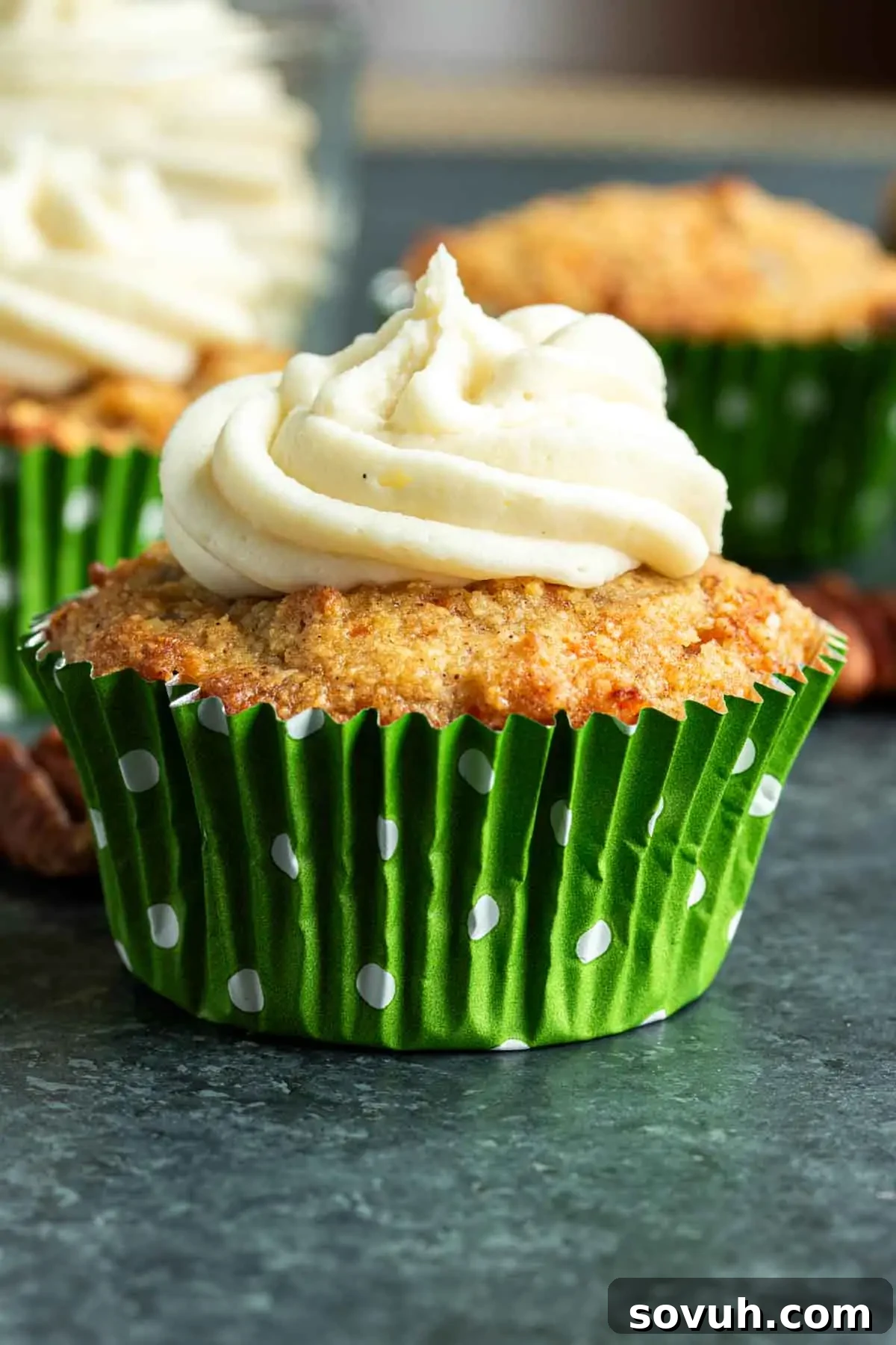 A vibrant collage showcasing various angles of Keto Carrot Cake Cupcakes, some frosted with cream cheese and pecans, one in a festive green polka-dot liner.