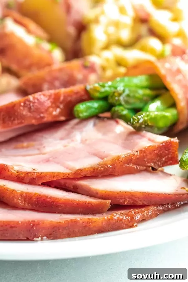 Honey glazes ham on a plate with sides