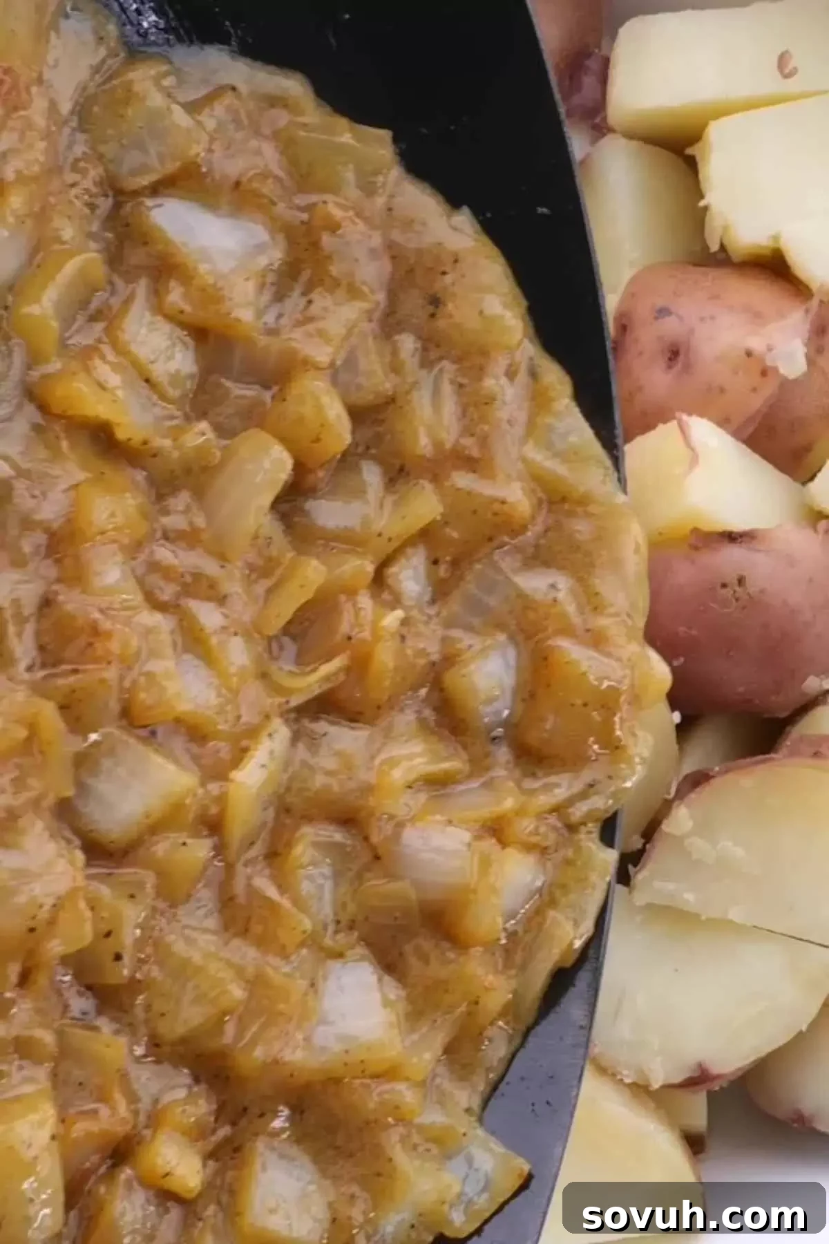 A skillet on the stove, showing diced onions sautéing in reserved bacon fat, with vinegar and chicken stock being added, illustrating the creation of the tangy dressing for German potato salad.