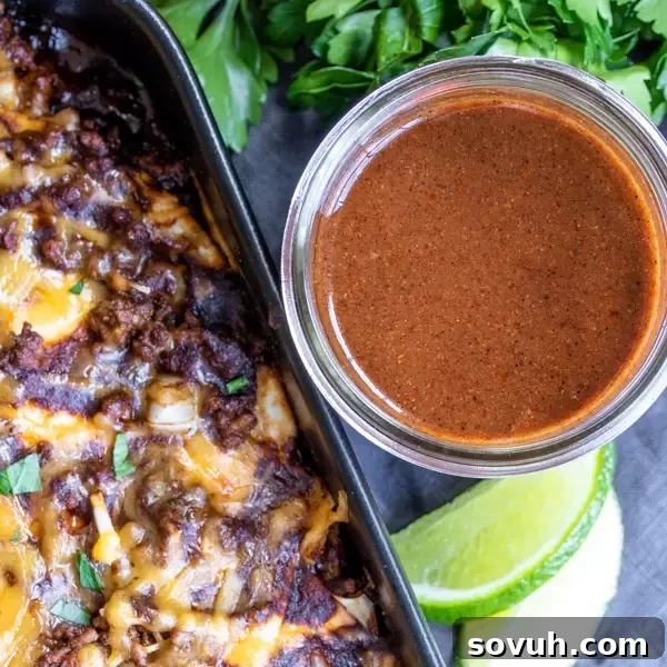 Homemade Red Enchilada Sauce next to an enchilada casserole, ready to be served