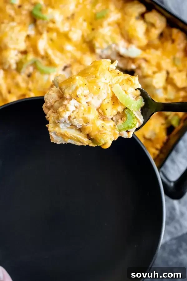 Serving individual portions of Keto Buffalo Chicken Cauliflower Casserole after baking