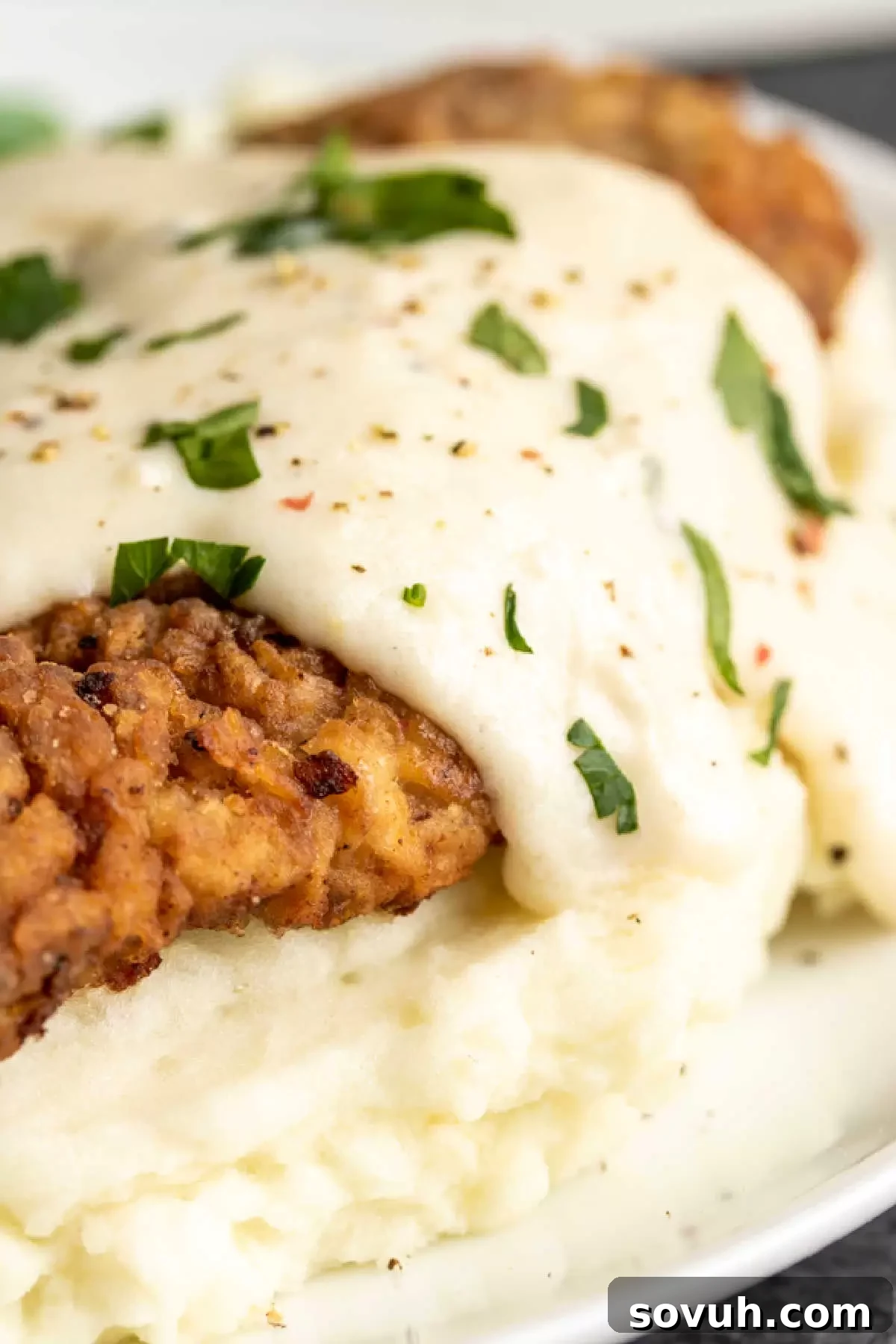 Chicken Fried Steak with Gravy dripping off the side, showcasing its rich texture