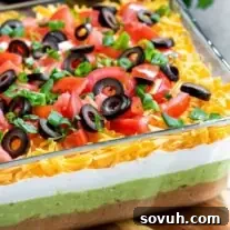 Prepared Mexican 7 Layer Dip in a glass dish, ready for serving at a party