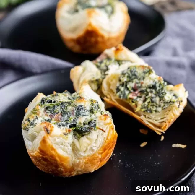 Spinach Puffs bites on a black plate, golden and appealing
