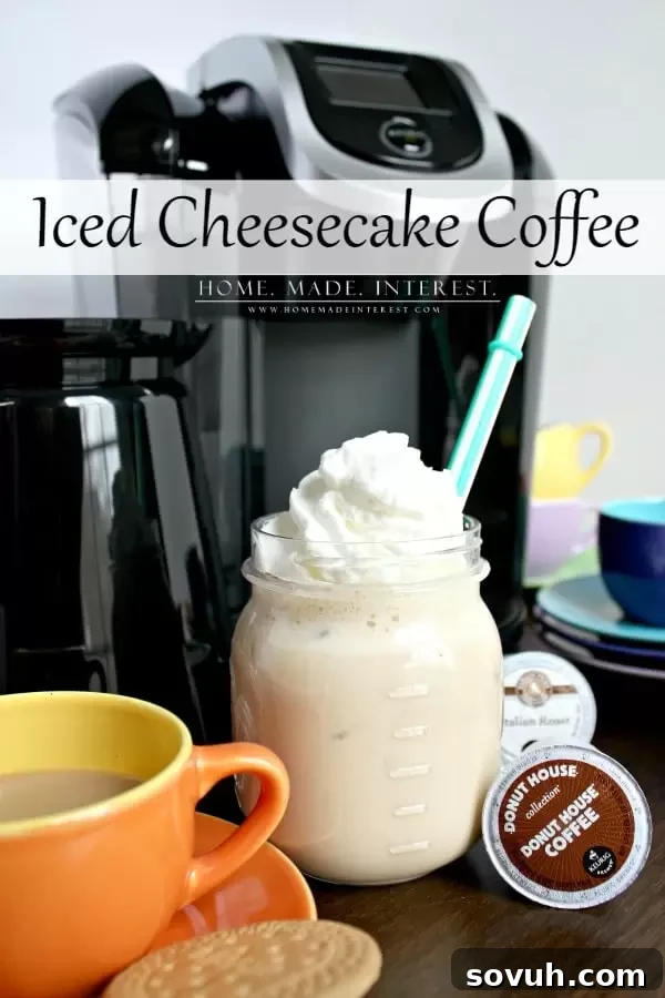 A tall glass of iced cheesecake coffee topped with whipped cream, made with a Keurig 2.0 brewer in the background, set on a rustic wooden surface.