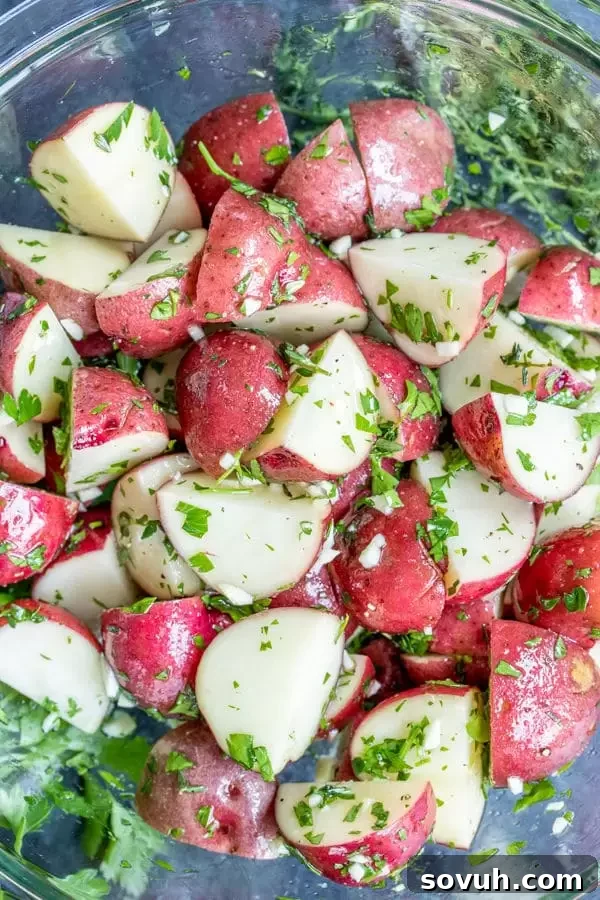 Fresh Ingredients for Flavorful Garlic Potatoes Ingredients to make Foil Packet Garlic Potatoes including chopped potatoes, fresh herbs, and olive oil