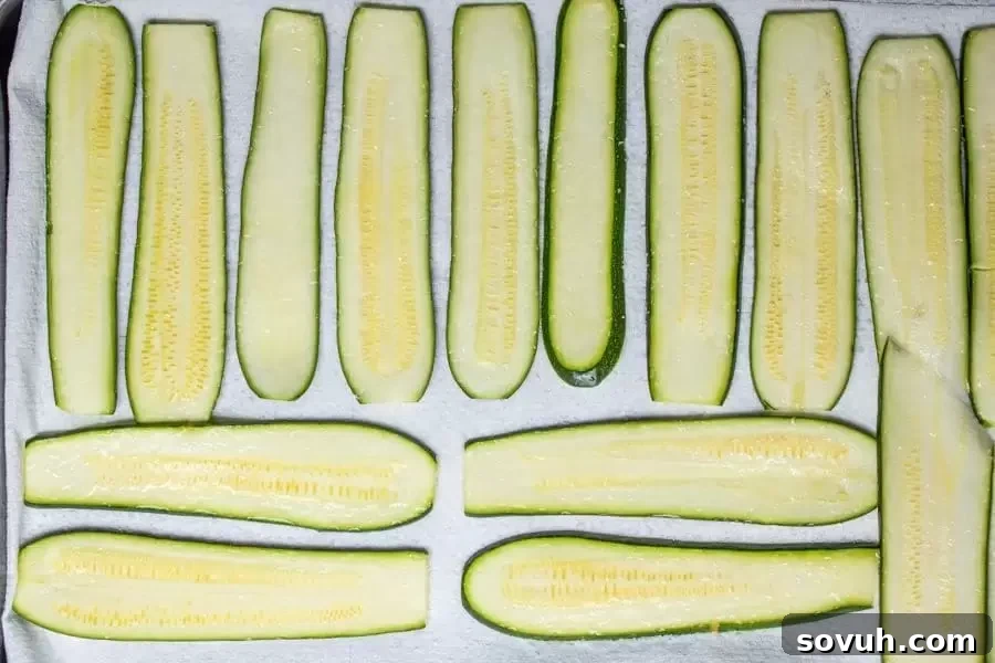 A step-by-step image demonstrating how to prepare zucchini for lasagna by salting and drying slices.