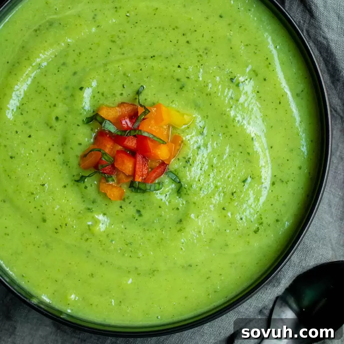 A beautifully presented bowl of creamy zucchini soup, garnished with fresh herbs and a drizzle of olive oil, ready to be enjoyed.
